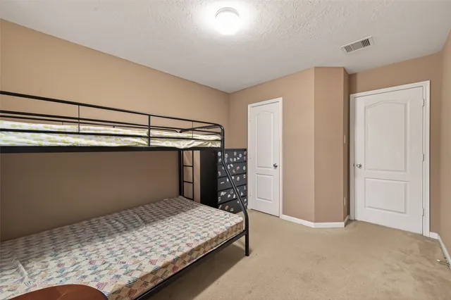 a bedroom with a bed and a cabinet