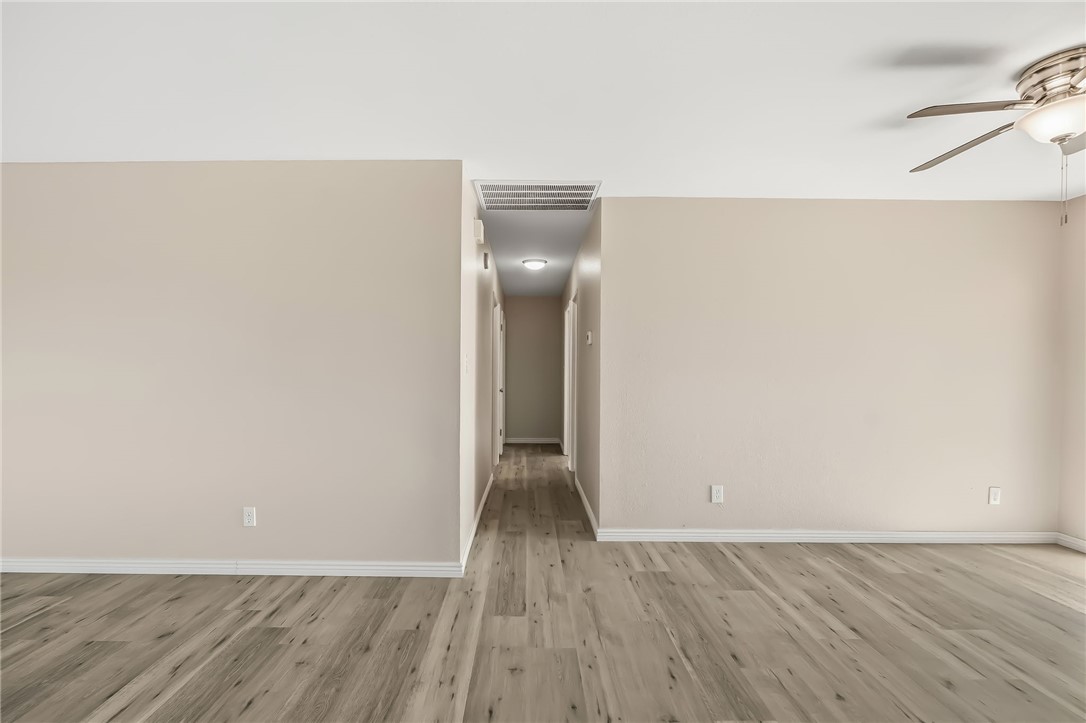 1720 Valencia Road Fort Mohave, AZ 86426 - Photo 20 of 32 Spacious interior room featuring wood-finish flooring, neutral wall paint, and white baseboards