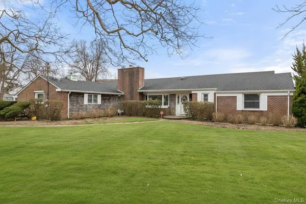 a front view of house with yard and green space