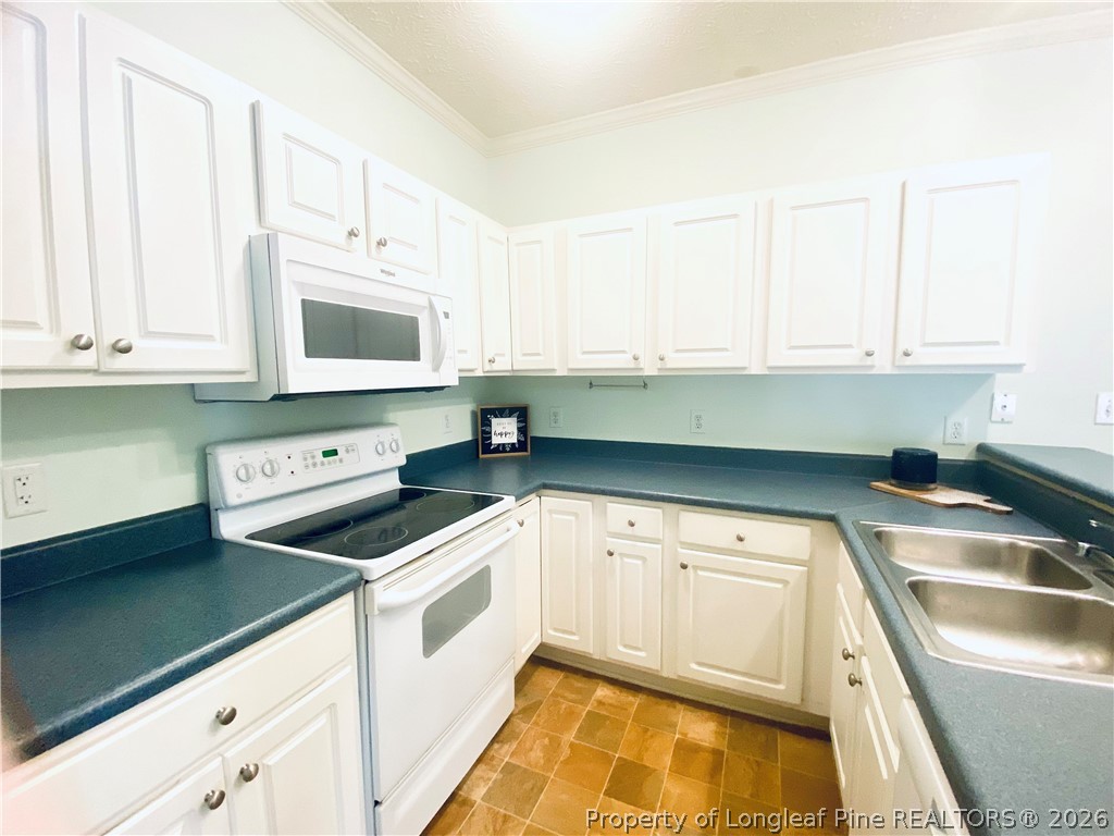 516 Lionshead Road, Unit 6 Fayetteville, NC 28311 - Photo 12 of 27 a kitchen with granite countertop white cabinets and white appliances