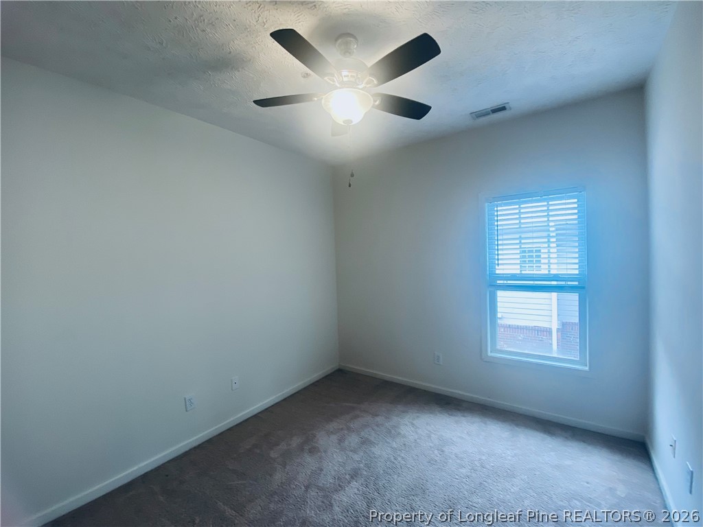 516 Lionshead Road, Unit 6 Fayetteville, NC 28311 - Photo 18 of 27 an empty room with a window and a ceiling fan