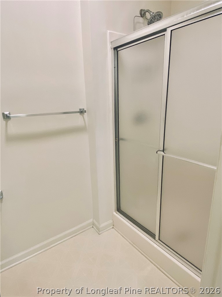 516 Lionshead Road, Unit 6 Fayetteville, NC 28311 - Photo 23 of 27 a bathroom with a glass shower door
