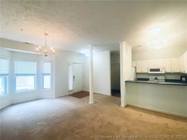 a view of a kitchen with a sink and cabinet area
