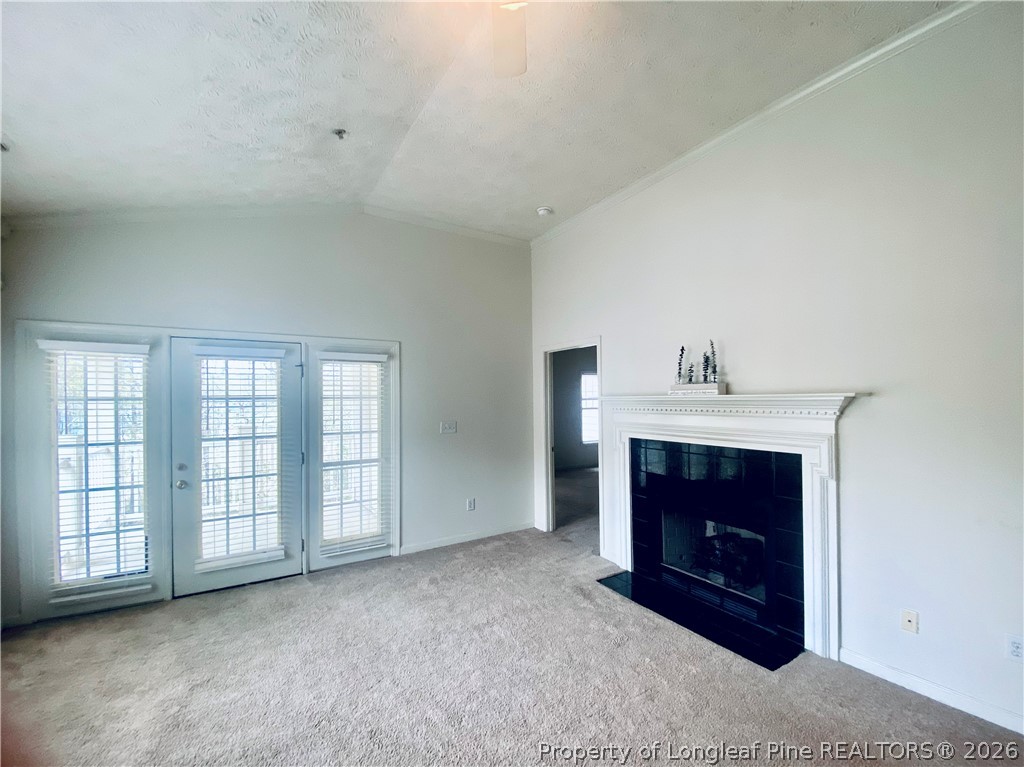 516 Lionshead Road, Unit 6 Fayetteville, NC 28311 - Photo 7 of 27 a big room with a fireplace and chandelier