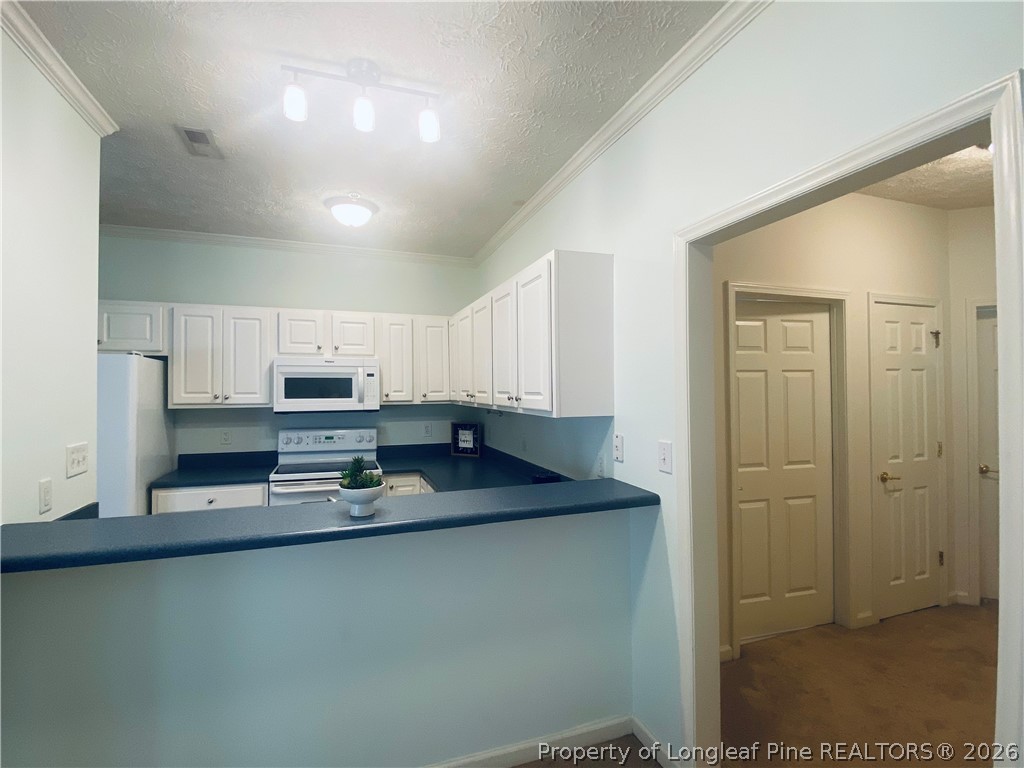 516 Lionshead Road, Unit 6 Fayetteville, NC 28311 - Photo 10 of 27 a kitchen with stainless steel appliances granite countertop a sink a stove a refrigerator a microwave a counter top and cabinets