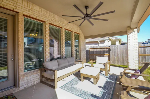 a outdoor space with patio the couches and a dining table with the potted plant