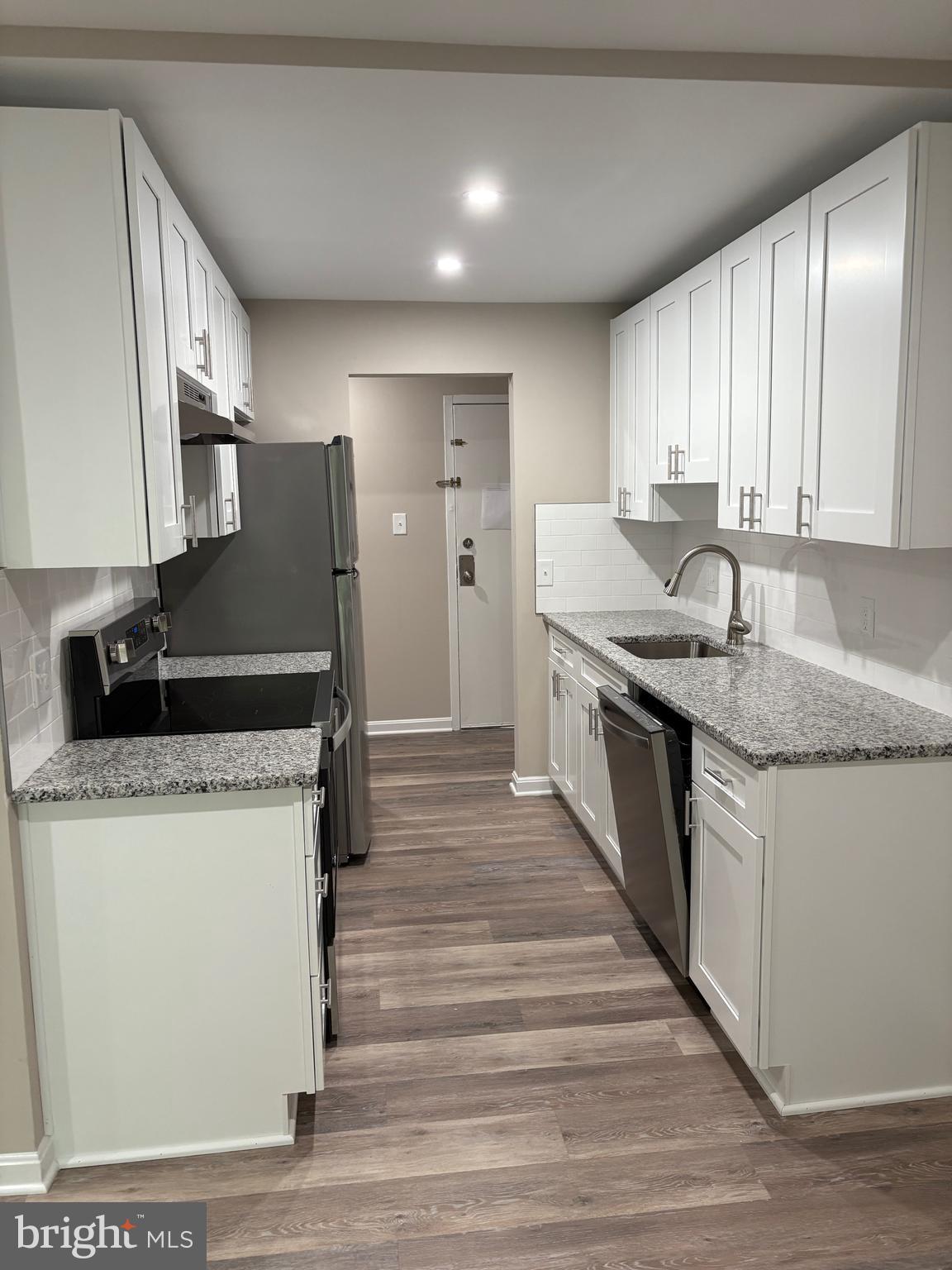 11611 Stoneview Square, Unit 70/12C Reston, VA 20191 - Photo 3 of 12 a kitchen with stainless steel appliances granite countertop a sink stove and refrigerator