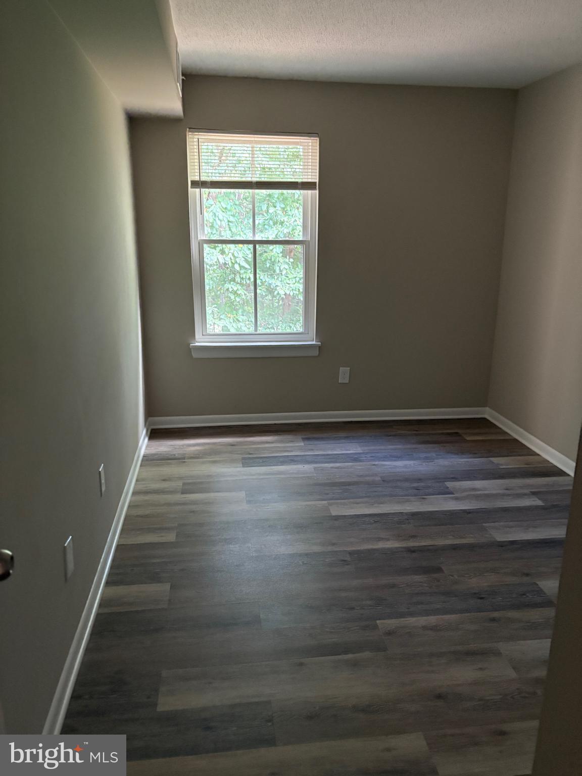 11611 Stoneview Square, Unit 70/12C Reston, VA 20191 - Photo 10 of 12 a view of room with window and hardwood floor