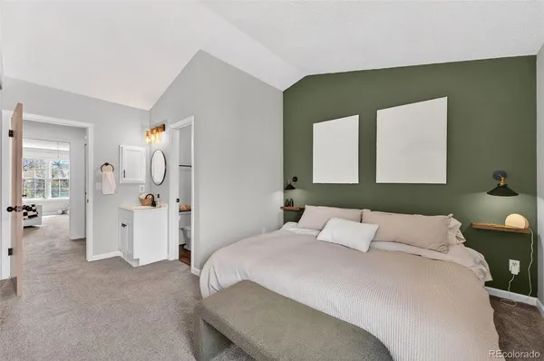 a bedroom with a bed and a mirror
