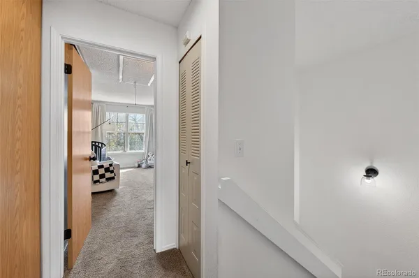 a hallway with white walls and furniture