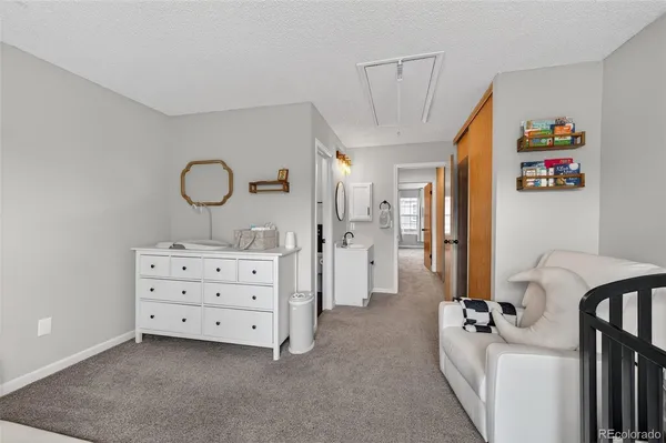 a view of a bedroom with baby crib