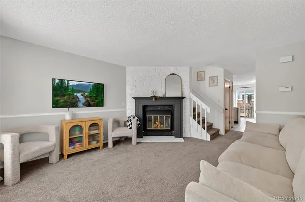 a living room with furniture and a fireplace
