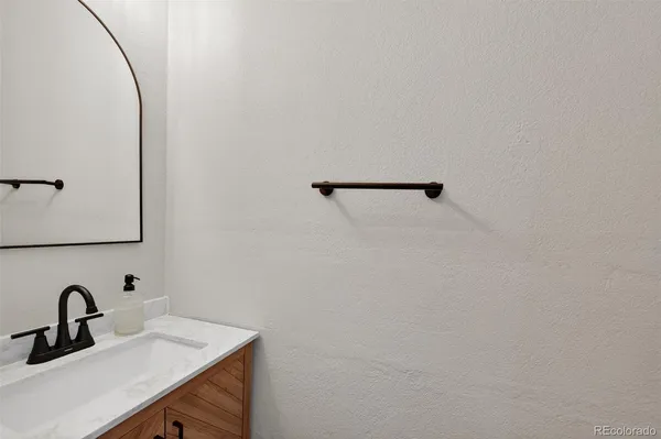 a bathroom with a sink and mirror