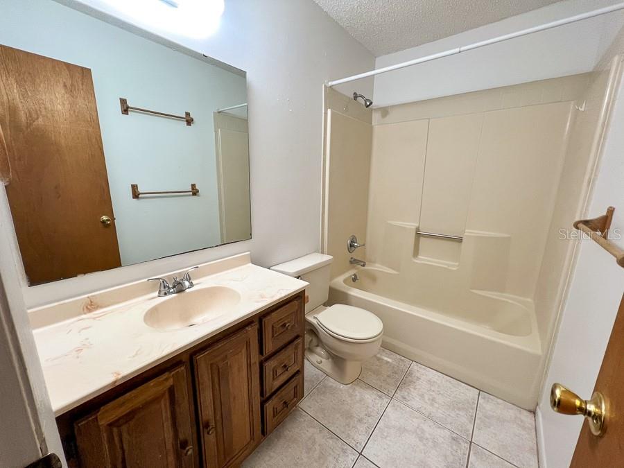 5601 Ave H, Unit 3 McIntosh, FL 32664 - Photo 16 of 21 a bathroom with a sink a toilet a mirror and shower