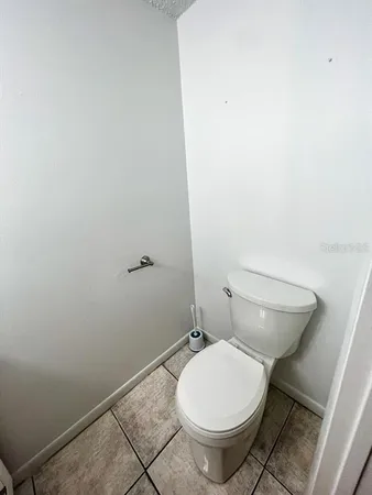 a white toilet sitting next to a shower