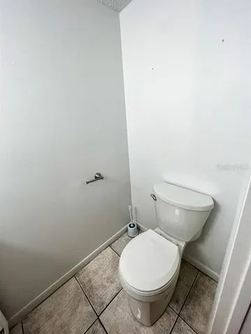 a white toilet sitting next to a shower
