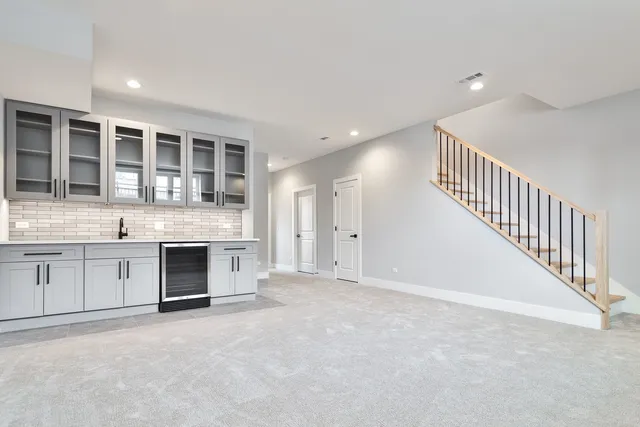 a view of an empty room with a kitchen
