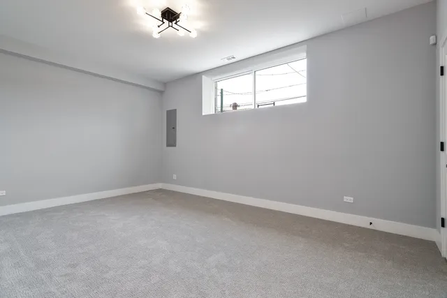 an empty room with a window and a ceiling fan