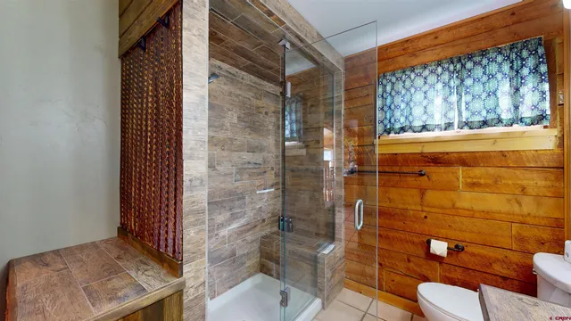 a bathroom with a toilet and shower