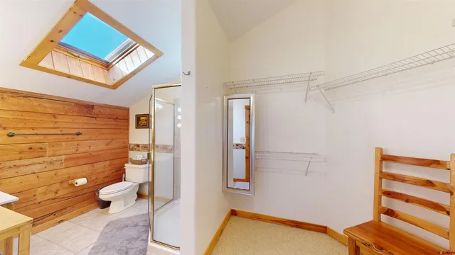 a bathroom with a toilet and a shower