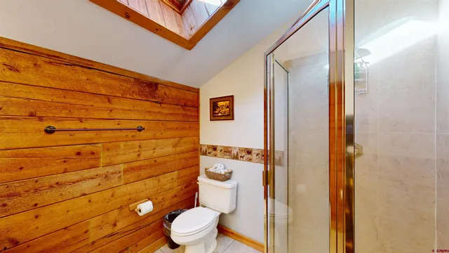 a bathroom with a toilet and a shower