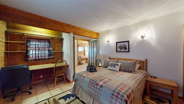 a bedroom with a bed and a desk