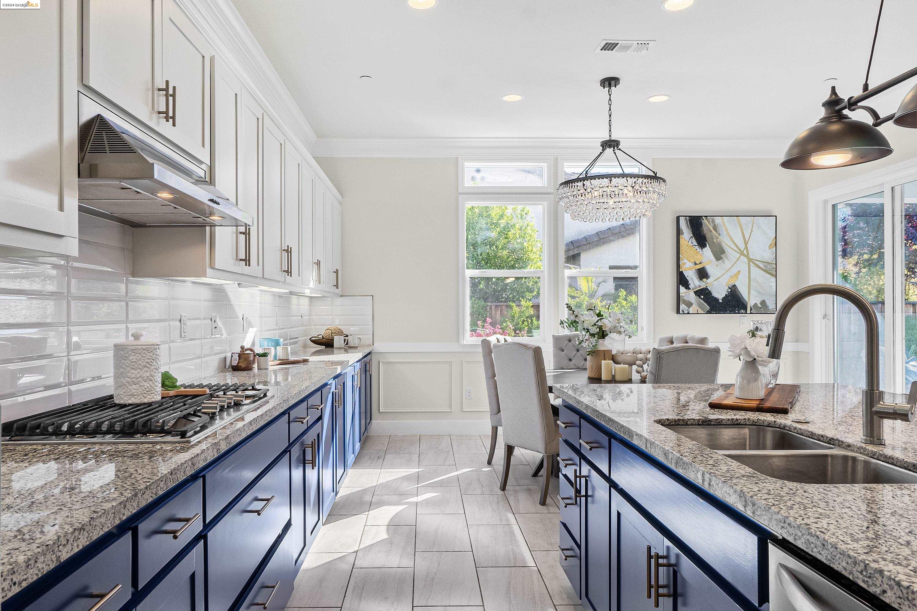 910 Puma Way Gilroy, CA 95020 - Photo 1 of 1 a kitchen with granite countertop a sink stove and cabinets