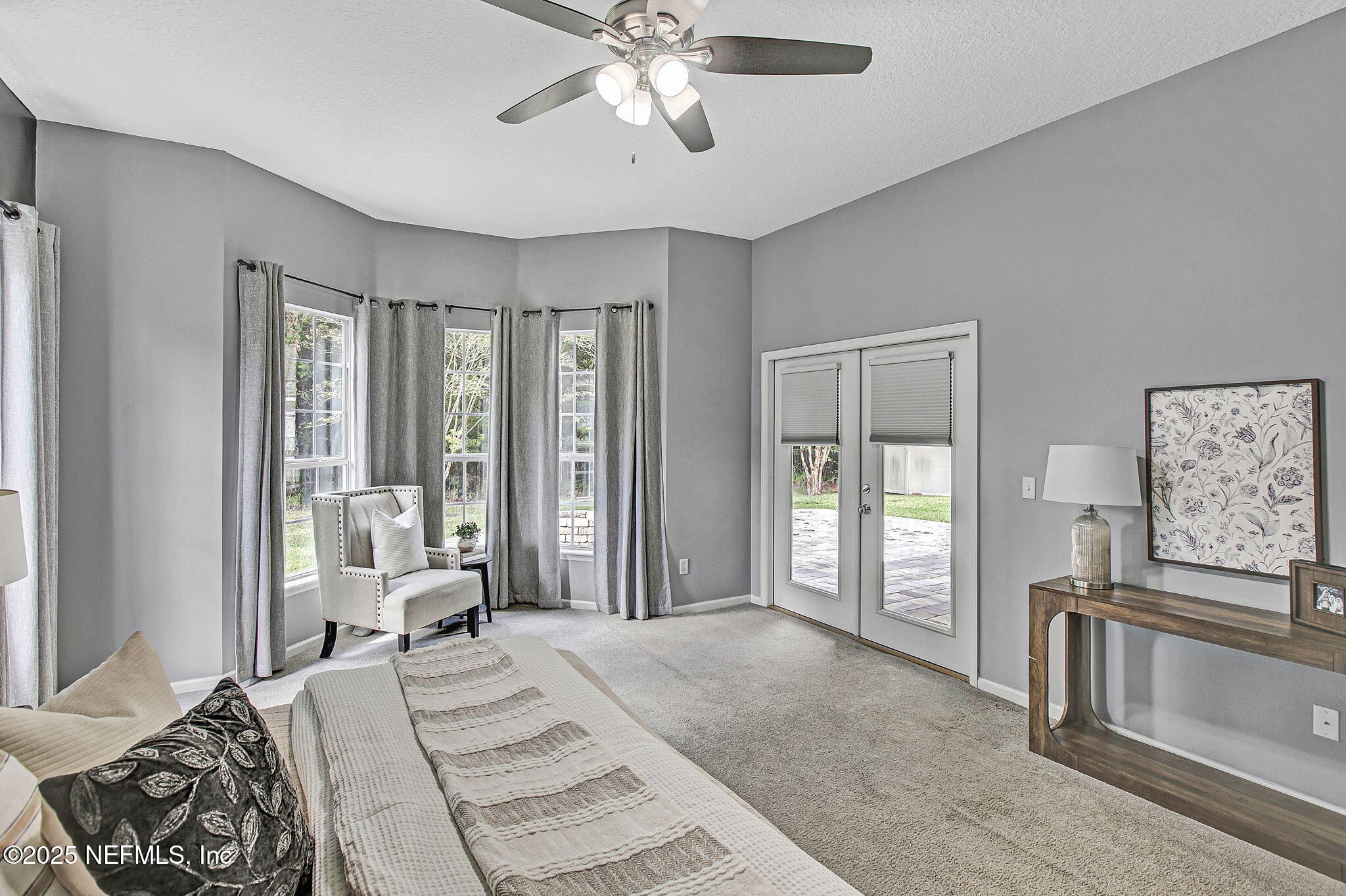 1961 Glenfield Crossing Court St. Augustine, FL 32092 - Photo 11 of 40 a bedroom with a large bed and a chandelier