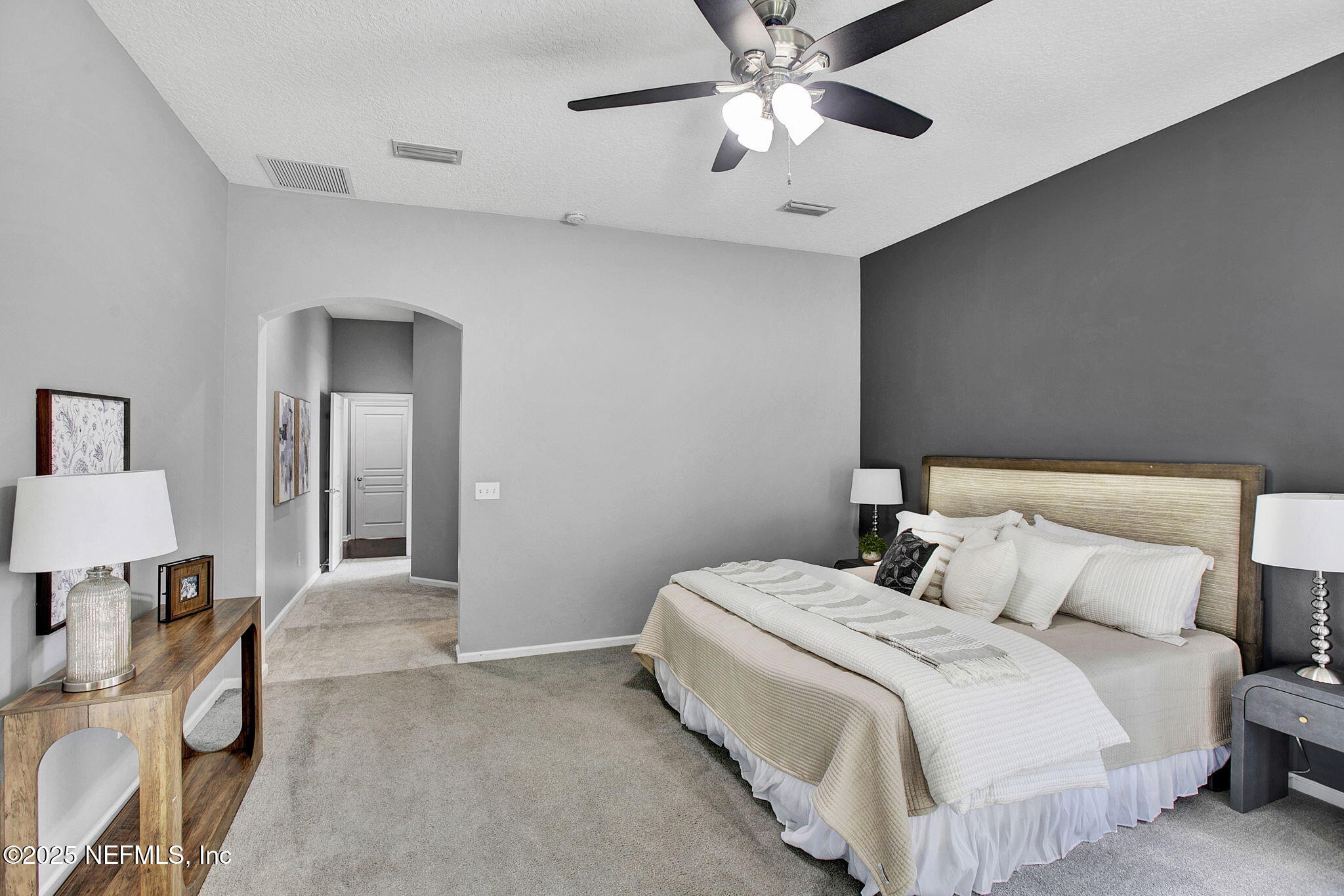 1961 Glenfield Crossing Court St. Augustine, FL 32092 - Photo 12 of 40 a bedroom with a bed and a chandelier