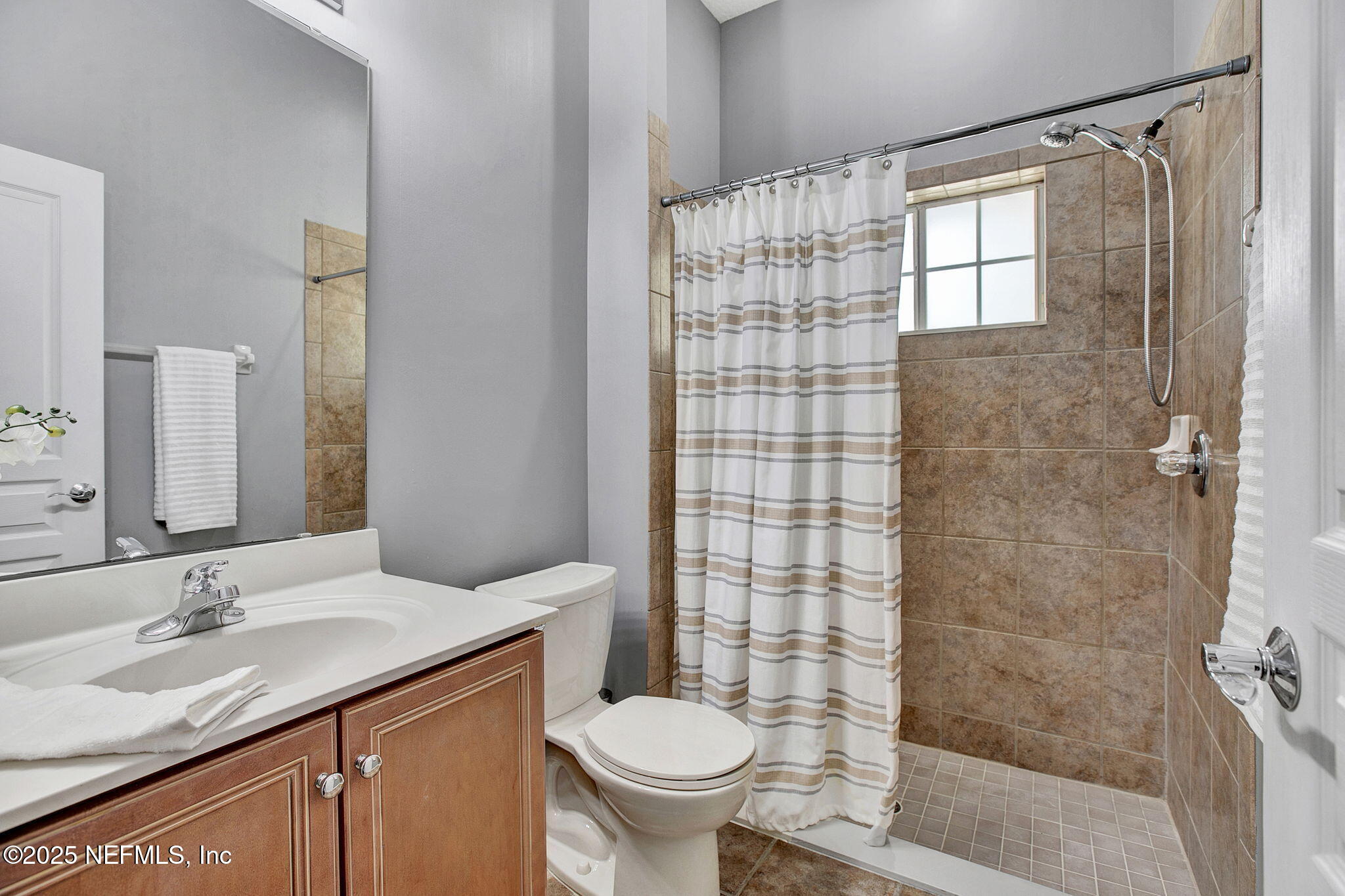 1961 Glenfield Crossing Court St. Augustine, FL 32092 - Photo 15 of 40 a bathroom with a granite countertop sink toilet and shower