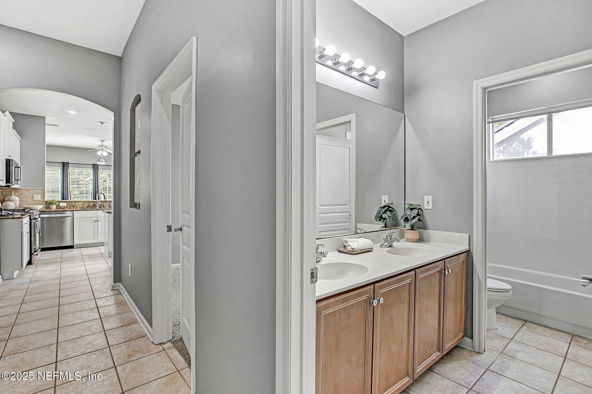 1961 Glenfield Crossing Court St. Augustine, FL 32092 - Photo 34 of 40 a bathroom with a sink a toilet and mirror