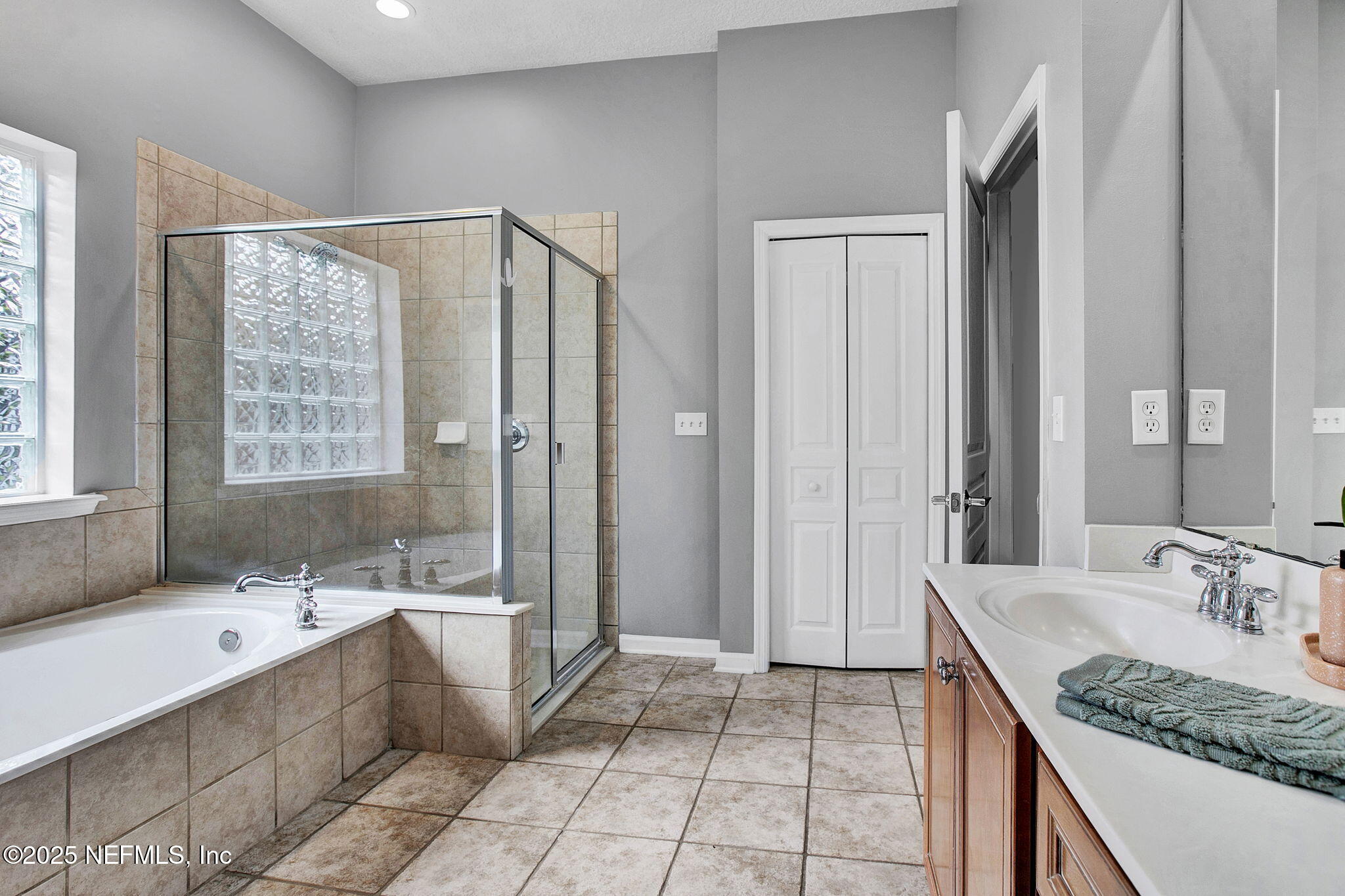 1961 Glenfield Crossing Court St. Augustine, FL 32092 - Photo 9 of 40 a bathroom with a granite countertop sink and a mirror