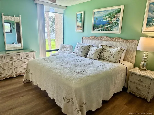 a large bed sitting in a bedroom next to a window