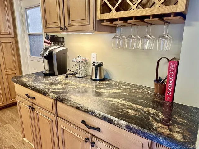 a kitchen with a sink a stove and wooden cabinets