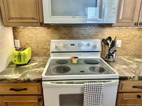 a stove top oven sitting inside of a kitchen