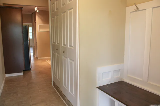 a view of a hallway with wooden floor