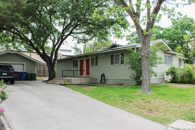 a front view of house with yard and green space