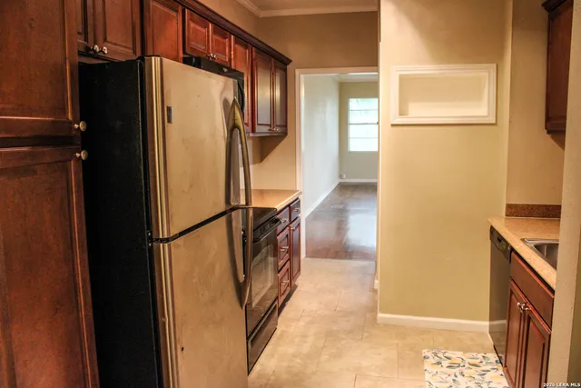 a view of walk in closet and bedroom