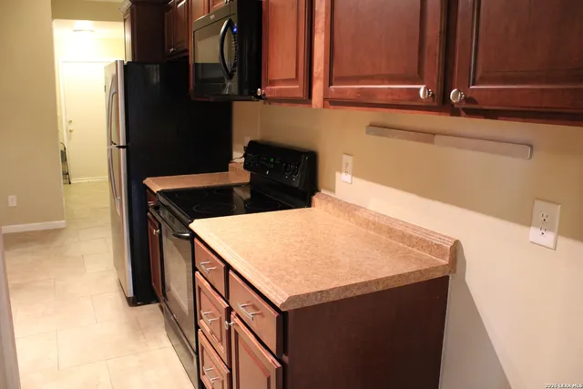a kitchen with a sink and a refrigerator