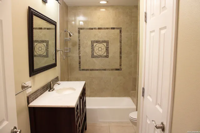 a bathroom with a sink a mirror and a bathtub