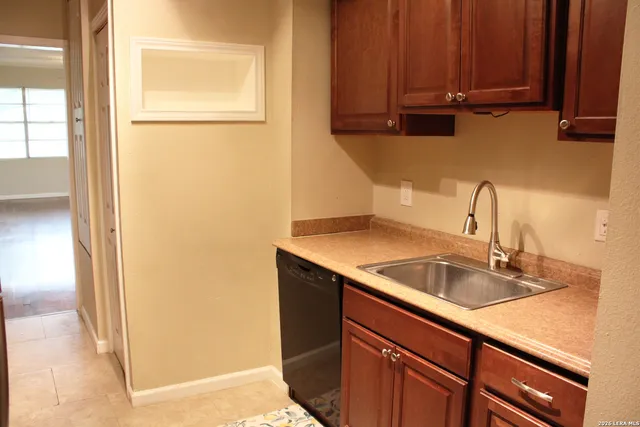 a kitchen with a sink and a refrigerator