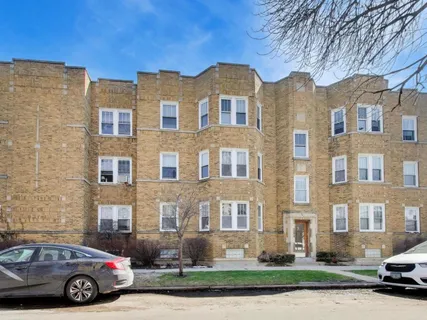 a front view of a residential apartment building with a yard