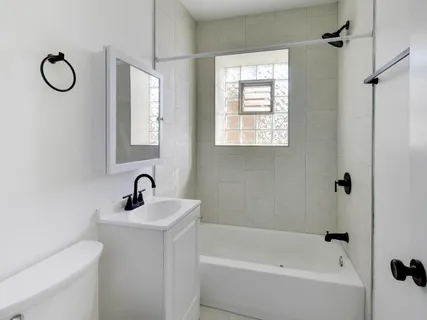 a bathroom with a toilet sink and shower