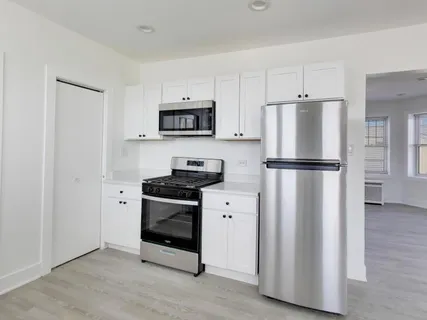 a kitchen with stainless steel appliances a refrigerator a stove a microwave and cabinets