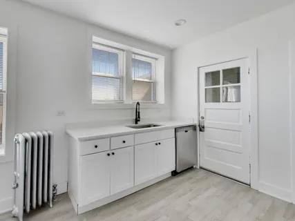 a spacious bathroom with a double vanity sink a mirror and a bathtub
