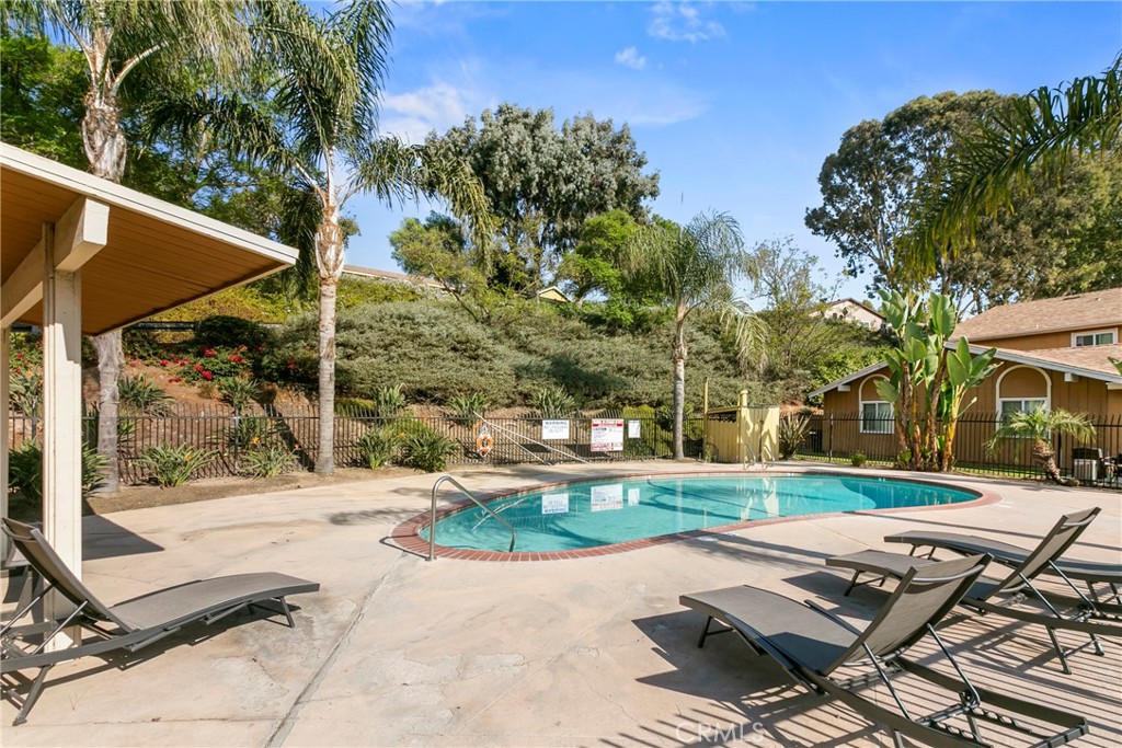 10472 Caminito Rimini San Diego, CA 92129 - Photo 26 of 27 a view of a patio with a table and chairs under an umbrella