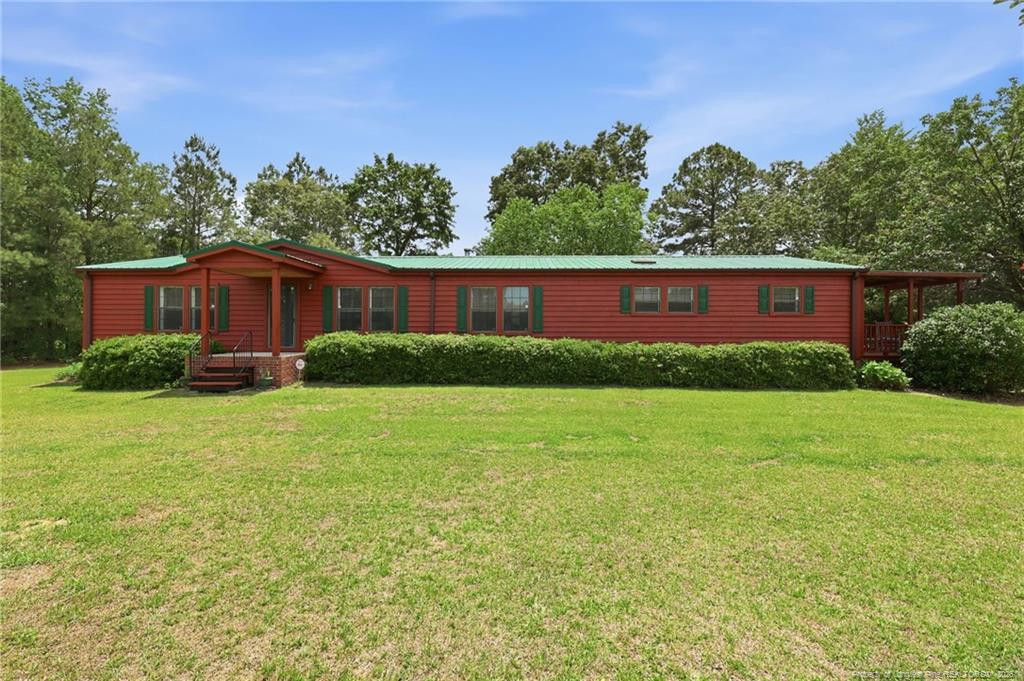 10400 Ruth Vinson Road Autryville, NC 28318 - Photo 13 of 49 a view of a yard in front of a house