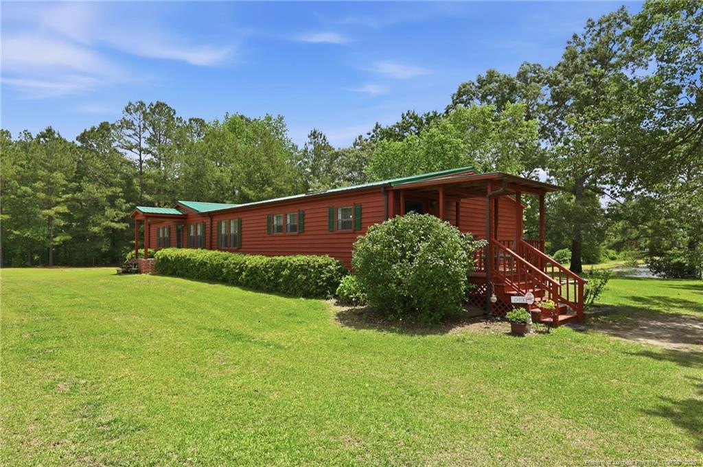 10400 Ruth Vinson Road Autryville, NC 28318 - Photo 14 of 49 a view of backyard with garden and trees
