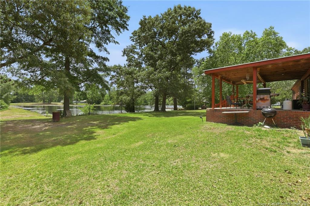 10400 Ruth Vinson Road Autryville, NC 28318 - Photo 17 of 49 a view of outdoor space with deck and garden