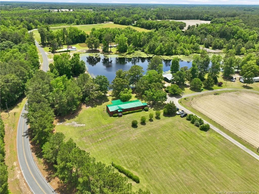 10400 Ruth Vinson Road Autryville, NC 28318 - Photo 2 of 49 an aerial view of residential houses with outdoor space and lake view